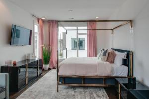 a bedroom with a canopy bed and a window at 4 Connecting Condos - Sleeps 32 to 36 - Firepits - Garages - Rooftops decks - Great Views - Security in Nashville