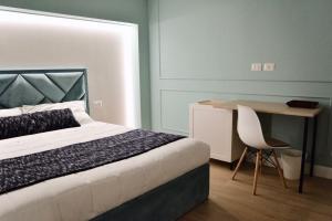 a bedroom with a bed and a desk and a chair at Guest House Domus Gratia Russo in Rome
