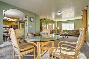 a dining room and living room with a table and chairs at Spacious Family Home, 3 Mi to Dtwn Cedar City in Cedar City