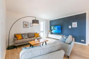 a living room with a couch and a table at Strandvilla Meeresblick Wohnung 02 in Boltenhagen