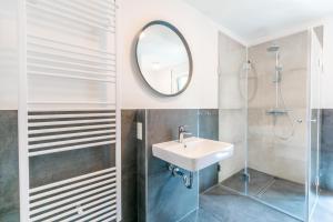 a bathroom with a sink and a mirror at Strandvilla Meeresblick Wohnung 02 in Boltenhagen +28 photos