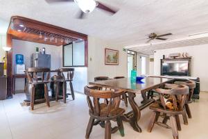 a dining room with a wooden table and chairs at Ayenda Casa Amarilla in Santa Marta