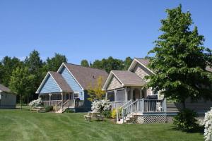 a large house with a porch and a yard at Brudenell Fairway Chalets in Georgetown