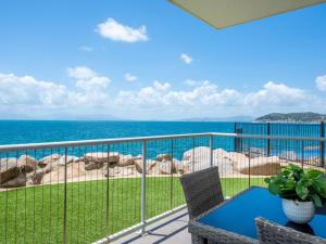 a balcony with a view of the ocean at 1 Bright Point Apartment 4105 in Nelly Bay