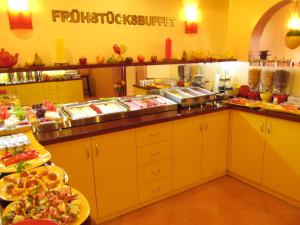 
a kitchen filled with lots of different types of food at Hotel am Hauptbahnhof in Schwerin
