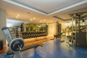 a gym with dumbbells and weights in a room at Le CanarD Joinville in Joinville