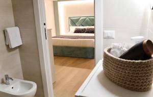 a bathroom with a sink and a bedroom with a bed at Guest House Domus Gratia Russo in Rome