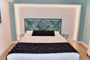 a bedroom with a large bed with a black headboard at Guest House Domus Gratia Russo in Rome