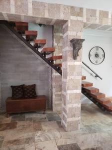 a room with a spiral staircase and a clock at Brothers Townhouse Puerto Peñasco, Centro in Puerto Peñasco