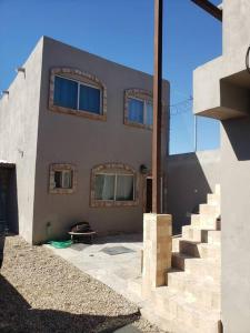 a house with a staircase in front of it at Brothers Townhouse Puerto Peñasco, Centro in Puerto Peñasco