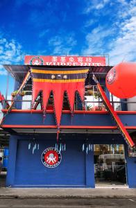 a building with a red banner on the side of it at Kuree Hut in Semporna