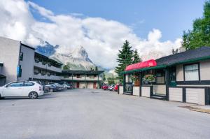 a parking lot with a mountain in the background at The Drake Inn in Canmore