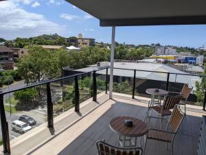 a balcony with a table and chairs and a view at The Windsor Hotel Rooms and Apartments, Brisbane in Brisbane