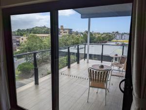 a balcony with a table and a view of the water at The Windsor Hotel Rooms and Apartments, Brisbane in Brisbane