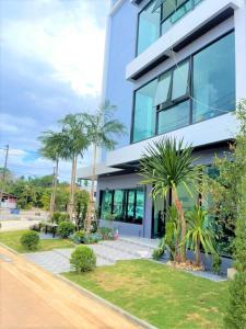 a building with palm trees in front of it at The Bliss Boutique Hotel 