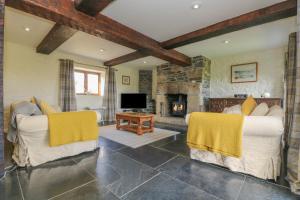 a living room with two chairs and a fireplace at Marhayes in Camelford