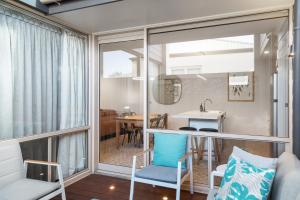 a living room with a table and chairs and a window at City Courtyard One Apartment in Mount Gambier