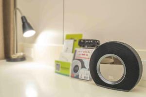 a speaker sitting on a counter next to boxes at 168 Motel-Taoyuan in Taoyuan