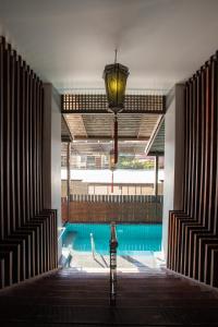 a swimming pool with a light fixture and a lamp at Night Bazaar Inn in Chiang Mai