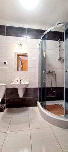 uma casa de banho com um lavatório e um chuveiro em Gościniec Na Stoku pokoje 2,3,4 osobowe, cisza, spokój, widok na stok narciarski, lasy, łaki em Bobliwo