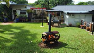 a backyard with a fire pit in the grass at Tolga Caravan Park in Tolga