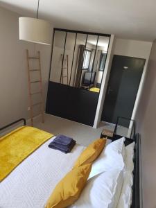 a bedroom with a bed and a large mirror at escapade in Amiens in Amiens