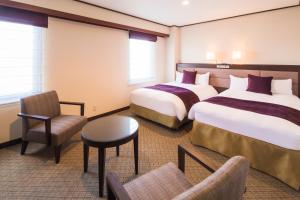 Posteľ alebo postele v izbe v ubytovaní Yonezawa Excel Hotel Tokyu Reopening on June 1 "DEN'S HOTEL yonezawa"