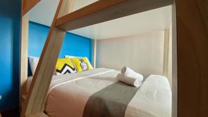 a bedroom with a bunk bed with a white bedspread at Sugar Marina Seaview Families Suite Apartment in Kuah