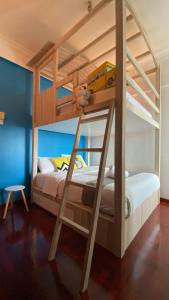 a bunk bed with a yellow bus on the bottom bunk at Sugar Marina Seaview Families Suite Apartment in Kuah
