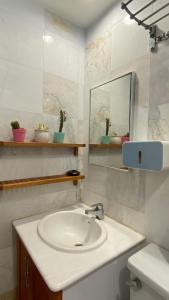 a bathroom with a sink and a mirror at Sugar Marina Seaview Families Suite Apartment in Kuah