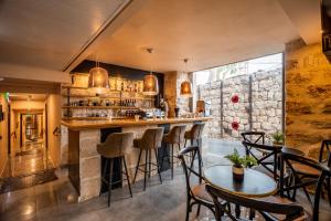 a bar in a restaurant with chairs and tables at Olive Heleni Hotel in Jerusalem