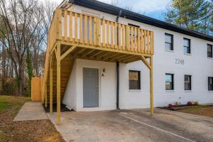 a house with a deck on top of it at Spacious and Cozy 2BR with Parking in Durham