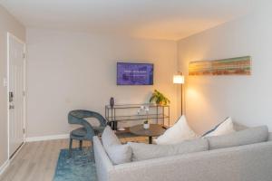 a living room with a couch and a chair at Spacious and Cozy 2BR with Parking in Durham