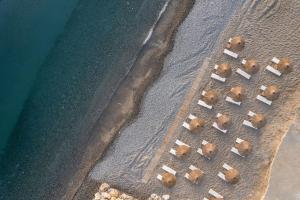 an aerial view of chairs on a beach next to the water at Avra Imperial Hotel in Kolymvari