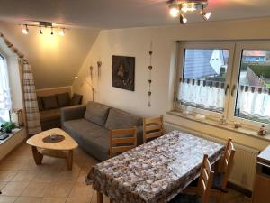 a living room with a couch and a table at Schulstrasse 10a Fewo in Zingst