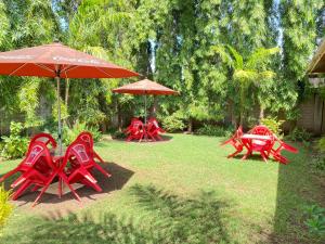 
a patio area with tables, chairs and umbrellas at Sangana Lodge in Moshi
