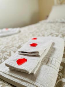 2 toallas con corazones rojos encima de una cama en La Casa dell'Arco en Vitorchiano
