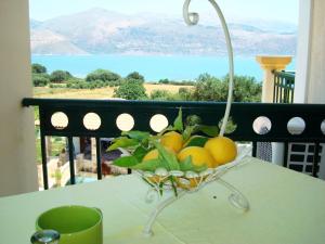 a basket of lemons on a table with a view at Remenata in Lixouri