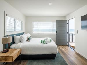 a bedroom with a bed and a table at The Marbella in Oceanside