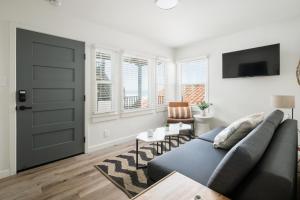 a living room with a couch and a door at The Marbella in Oceanside