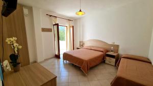 a hotel room with a bed and a window at Cocos Park Ischia in Ischia