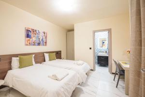 Postel nebo postele na pokoji v ubytování Atlantis Holiday Suites