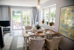 a dining room with a wooden table and chairs at Haus Sina in Boren