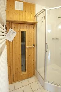 a bathroom with a shower and a glass door at Pamir in Boren