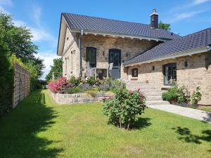 a brick house with a garden in front of it at Strandperle in Kosel