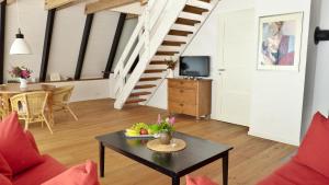 a living room with a coffee table and a staircase at Schleistern in Brodersby