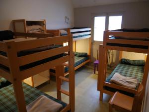 a room with several bunk beds and a window at Ostal - Auberge de jeunesse Concarneau in Concarneau