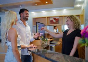 a man and two women standing at a counter at Züfle Hotel Restaurant Spa in Sulz am Neckar