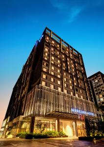 a large building with a sign on the front of it at Mercure Kuala Lumpur Glenmarie in Shah Alam