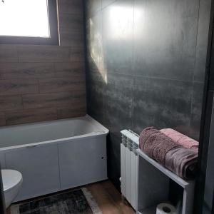 a bathroom with a tub and a toilet and a sink at Little Shangri-La in Almaty +86 photos